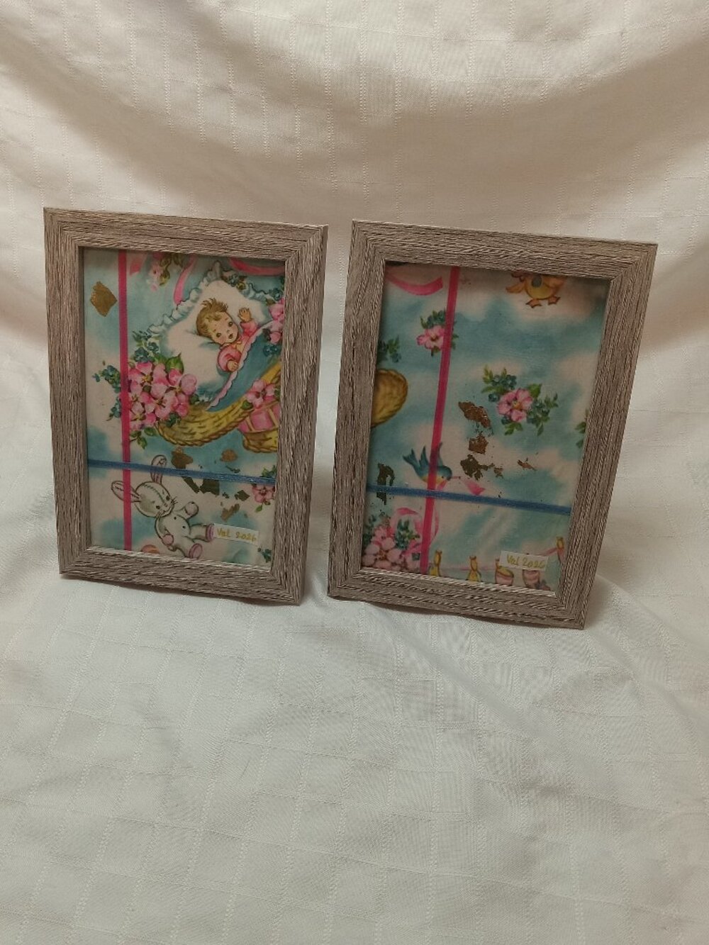 A set of delicate picture frames for a baby's room with vintage wrapping paper